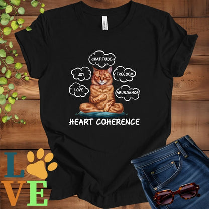 Black t-shirt with a meditating Abyssinian cat, surrounded by floating emotion bubbles labelled love, joy, gratitude, freedom, abundance, and 'Heart Coherence' slogan.