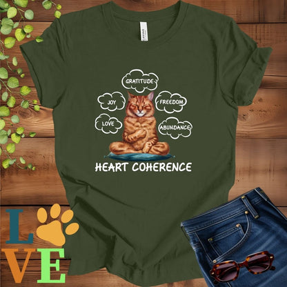 Olive green (military green) t-shirt with a meditating Abyssinian cat, surrounded by floating emotion bubbles labelled love, joy, gratitude, freedom, abundance, and 'Heart Coherence' slogan.

