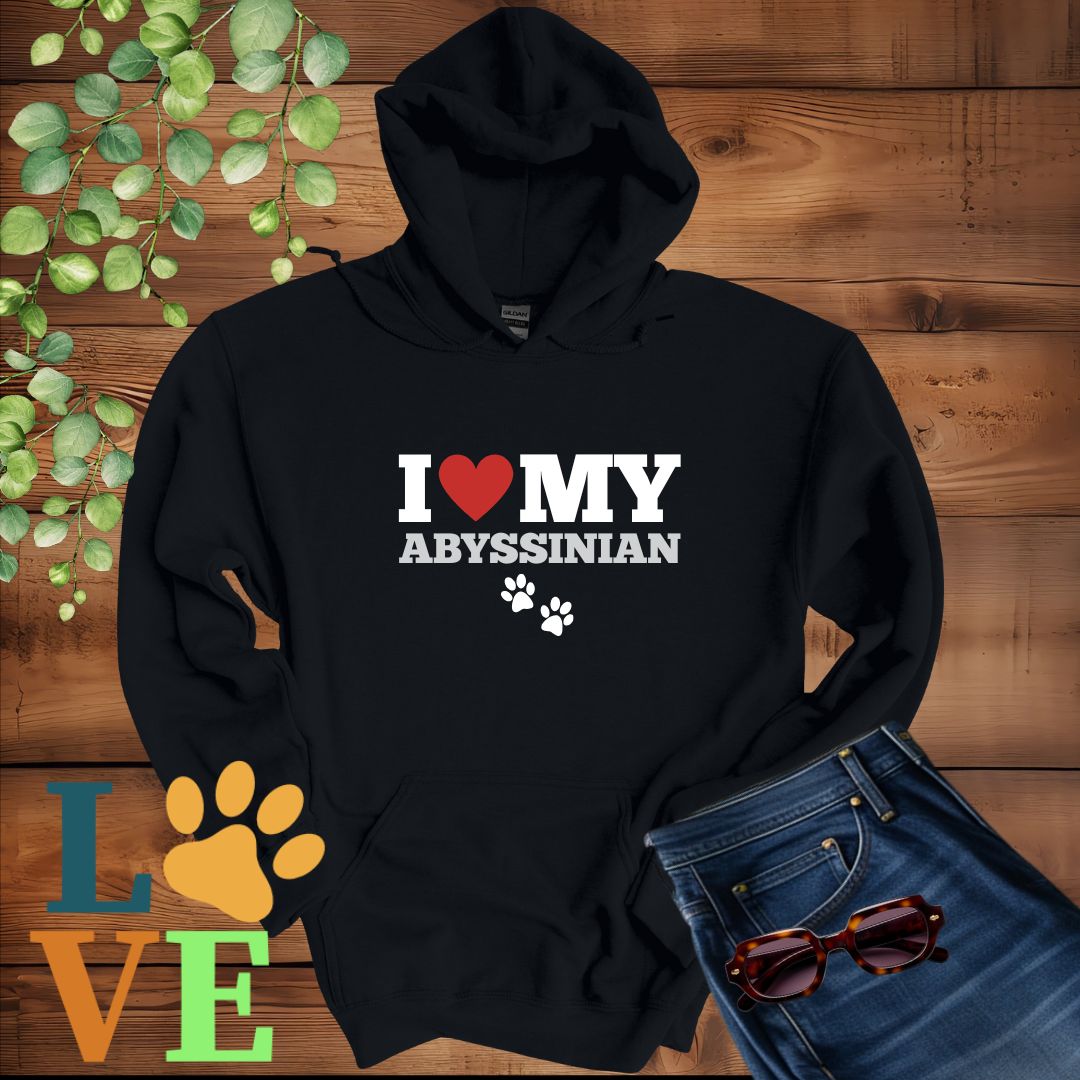 Black hoodie with 'I ❤️ MY ABYSSINIAN' text on a wooden background