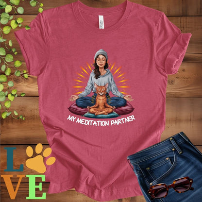 Muted raspberry pink (heather raspberry) t-shirt featuring a woman meditating with her Abyssinian cat and the slogan "My meditation partner".