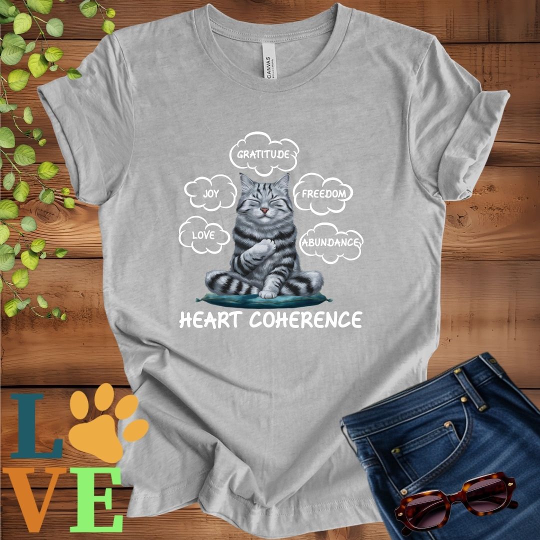 Light grey heather (athletic heather) t-shirt with a meditating American Shorthair cat, surrounded by floating emotion bubbles labelled love, joy, gratitude, freedom, abundance, and 'Heart Coherence' slogan.