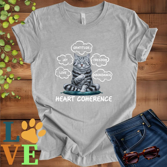 Light grey heather (athletic heather) t-shirt with a meditating American Shorthair cat, surrounded by floating emotion bubbles labelled love, joy, gratitude, freedom, abundance, and 'Heart Coherence' slogan.