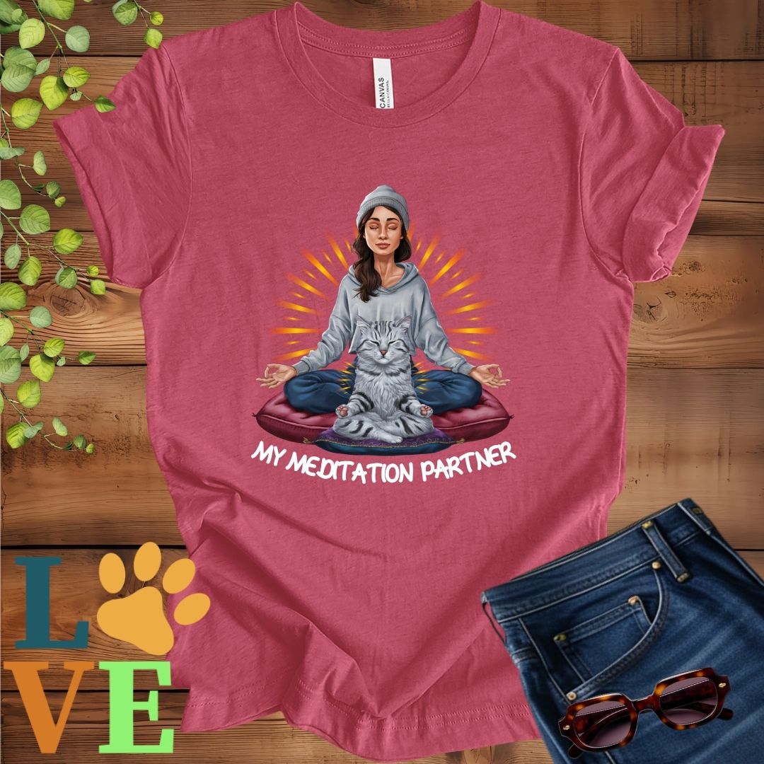 Muted raspberry pink (heather raspberry) t-shirt featuring a woman meditating with her American Shorthair cat and the slogan "My meditation partner".