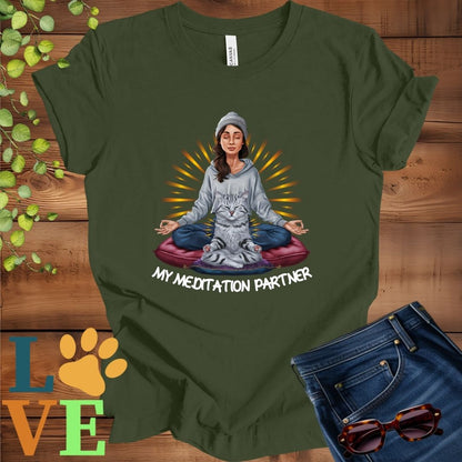 Olive green (military green) t-shirt featuring a woman meditating with her American Shorthair cat and the slogan "My meditation partner".