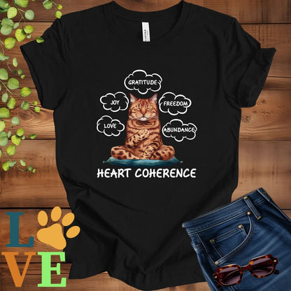 Black t-shirt with a meditating Bengal cat, surrounded by floating emotion bubbles labelled love, joy, gratitude, freedom, abundance, and 'Heart Coherence' slogan.