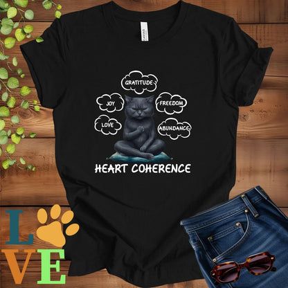 Black t-shirt with a meditating black cat, surrounded by floating emotion bubbles labelled love, joy, gratitude, freedom, abundance, and 'Heart Coherence' slogan.

