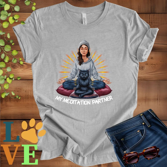 Light grey heather (athletic heather) t-shirt featuring a woman meditating with her black cat and the slogan "My meditation partner".