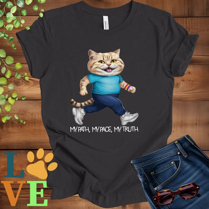 Dark grey heather t-shirt featuring an anthropomorphic British Shorthair cat in exercise wear walking confidently with the slogan, "My path, my pace, my truth."
