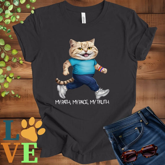 Dark grey heather t-shirt featuring an anthropomorphic British Shorthair cat in exercise wear walking confidently with the slogan, "My path, my pace, my truth."
