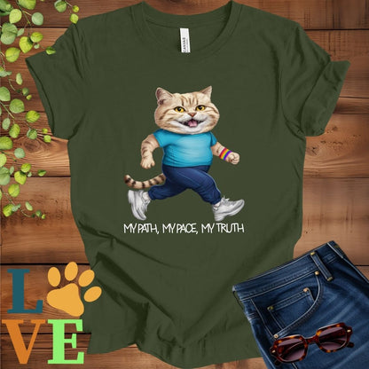 Olive green (military green) t-shirt featuring an anthropomorphic British Shorthair cat in exercise wear walking confidently with the slogan, "My path, my pace, my truth."