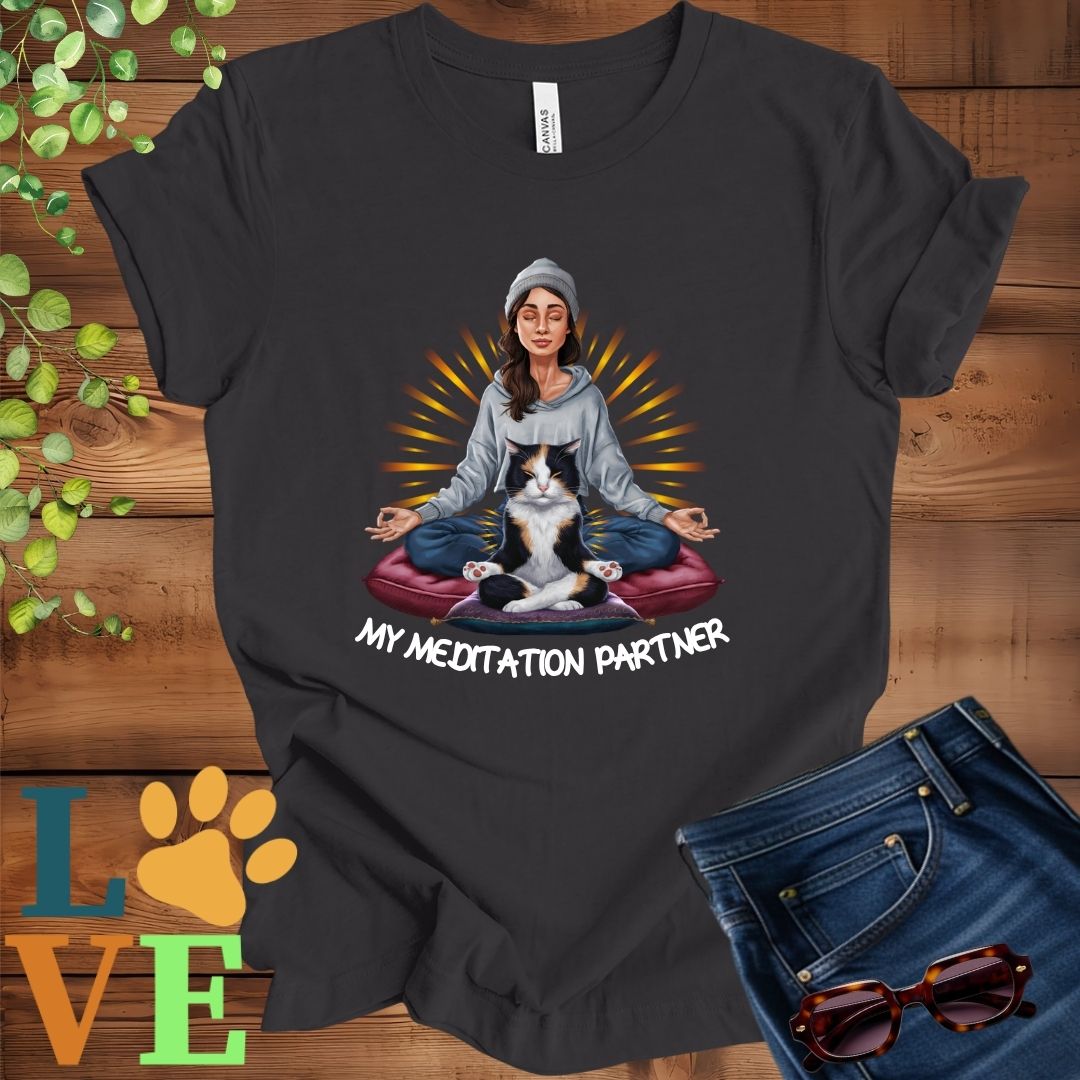 Dark grey heather t-shirt featuring a woman meditating with her calico cat and the slogan "My meditation partner".