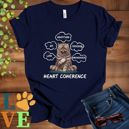 Navy Blue t-shirt with a meditating Exotic Shorthair cat, surrounded by floating emotion bubbles labelled love, joy, gratitude, freedom, abundance, and 'Heart Coherence' slogan.
