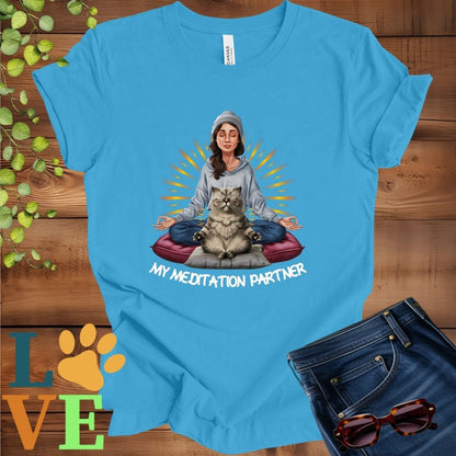 Bright aqua blue t-shirt featuring a woman meditating with her Exotic Shorthair cat and the slogan "My meditation partner".