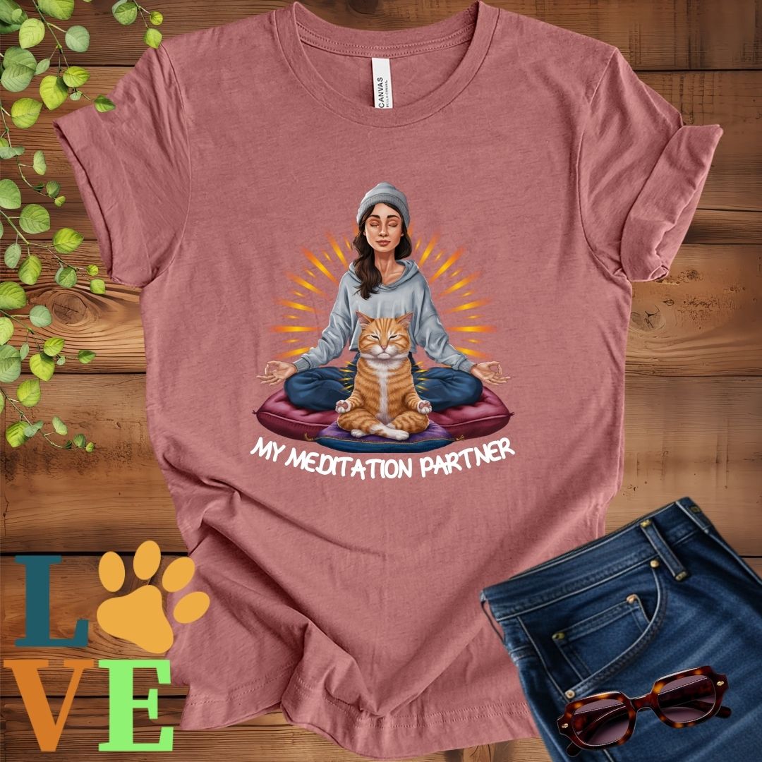 Muted mauve-purple (heather mauve) t-shirt featuring a woman meditating with her ginger cat and the slogan "My meditation partner".