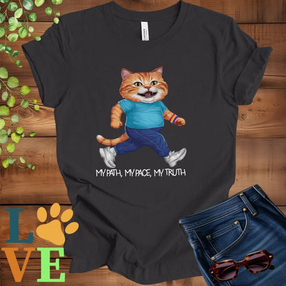 Dark grey heather t-shirt featuring an anthropomorphic ginger cat in exercise wear walking confidently with the slogan, "My path, my pace, my truth."