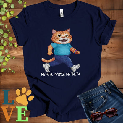 Navy blue t-shirt featuring an anthropomorphic ginger cat in exercise wear walking confidently with the slogan, "My path, my pace, my truth."
