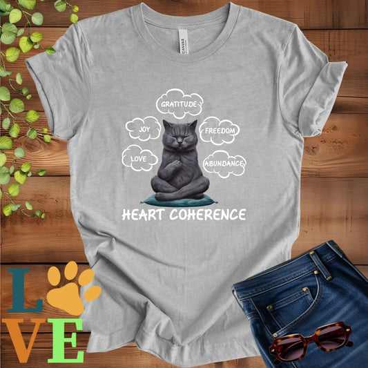 Light grey heather (athletic heather) t-shirt with a meditating gray British Shorthair cat, surrounded by floating emotion bubbles labelled love, joy, gratitude, freedom, abundance, and 'Heart Coherence' slogan.