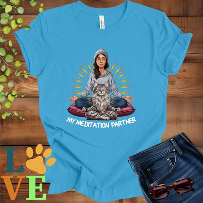 Bright aqua blue t-shirt featuring a woman meditating with her Maine Coon cat and the slogan "My meditation partner".