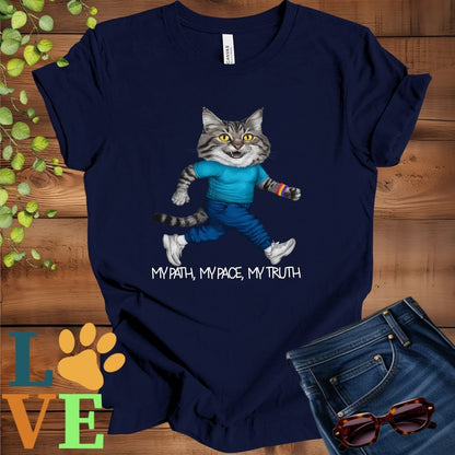 Navy blue t-shirt featuring an anthropomorphic Maine Coon cat in exercise wear walking confidently with the slogan, "My path, my pace, my truth."