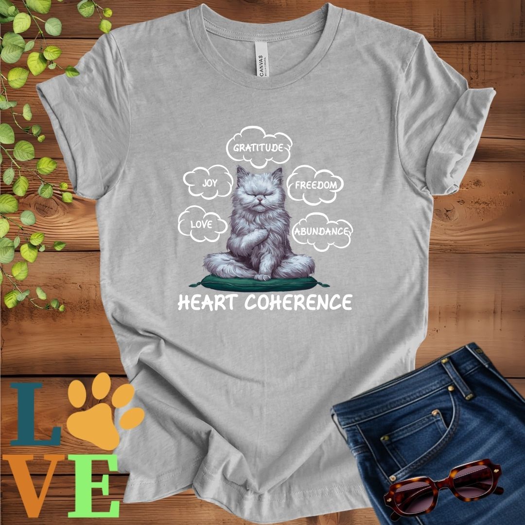 Light grey heather (athletic heather) t-shirt with a meditating Persian cat, surrounded by floating emotion bubbles labelled love, joy, gratitude, freedom, abundance, and 'Heart Coherence' slogan.