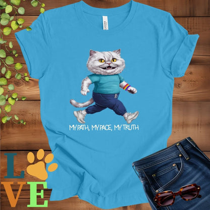 Bright aqua blue t-shirt featuring an anthropomorphic Persian cat in exercise wear walking confidently with the slogan, "My path, my pace, my truth."
