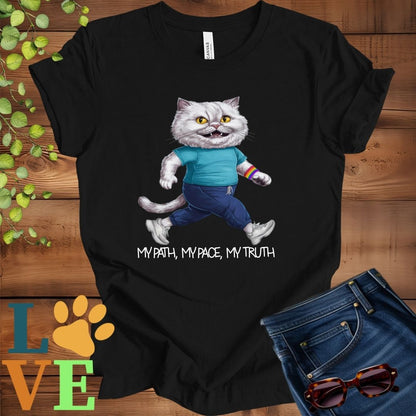 Black t-shirt featuring an anthropomorphic Persian cat in exercise wear walking confidently with the slogan, "My path, my pace, my truth."
