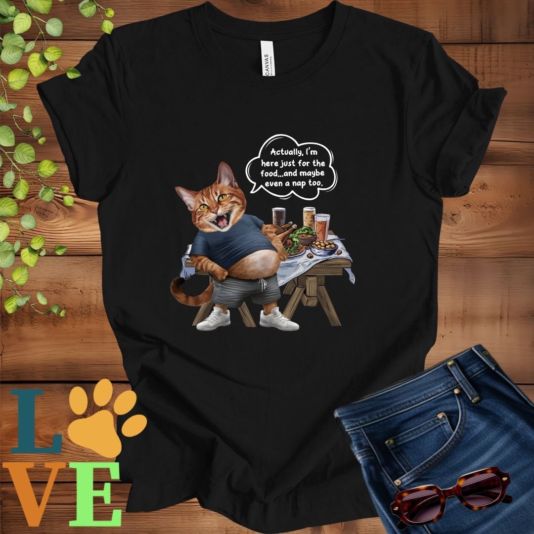 Black t-shirt with an anthropomorphic Abyssinian cat,  standing in front of a table with food and drinks, showing its pot belly and humorous speech bubble message.