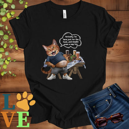 Black t-shirt with an anthropomorphic Abyssinian cat,  standing in front of a table with food and drinks, showing its pot belly and humorous speech bubble message.