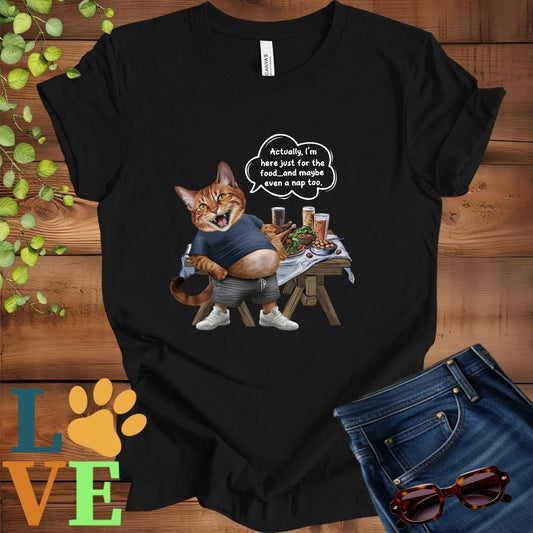 Black t-shirt with an anthropomorphic Abyssinian cat,  standing in front of a table with food and drinks, showing its pot belly and humorous speech bubble message.