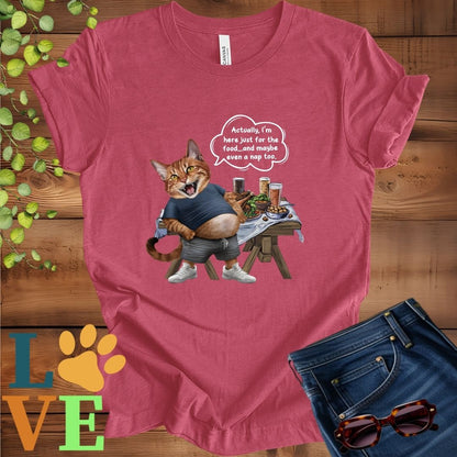 Muted raspberry pink (heather raspberry) t-shirt with an anthropomorphic Abyssinian cat,  standing in front of a table with food and drinks, showing its pot belly and humorous speech bubble message.