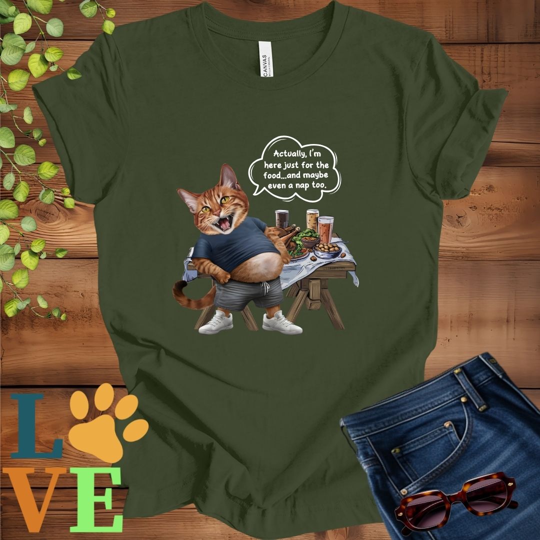 Olive green (military green) t-shirt with an anthropomorphic Abyssinian cat, standing in front of a table with food and drinks, showing its pot belly and humorous speech bubble message.