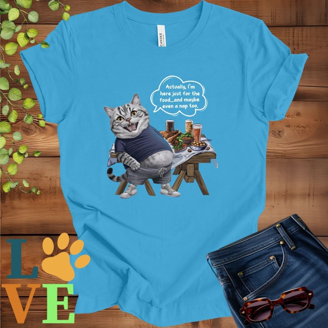Bright aqua blue t-shirt with an anthropomorphic American Shorthair cat, standing in front of a table with food and drinks, showing its pot belly and humorous speech bubble message.