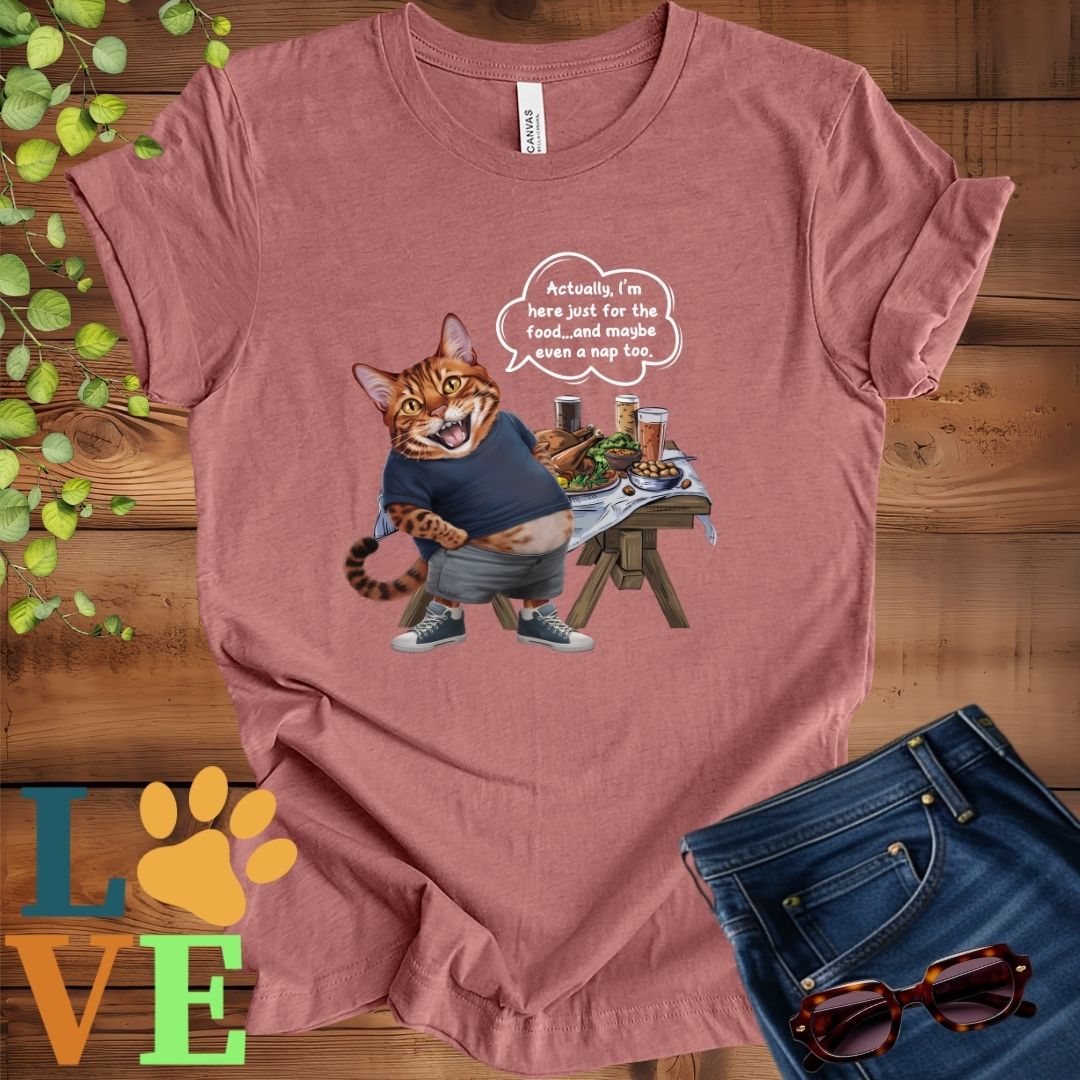 Muted mauve-purple (heather mauve) t-shirt with an anthropomorphic Bengal cat, standing in front of a table with food and drinks, showing its pot belly and humorous speech bubble message.