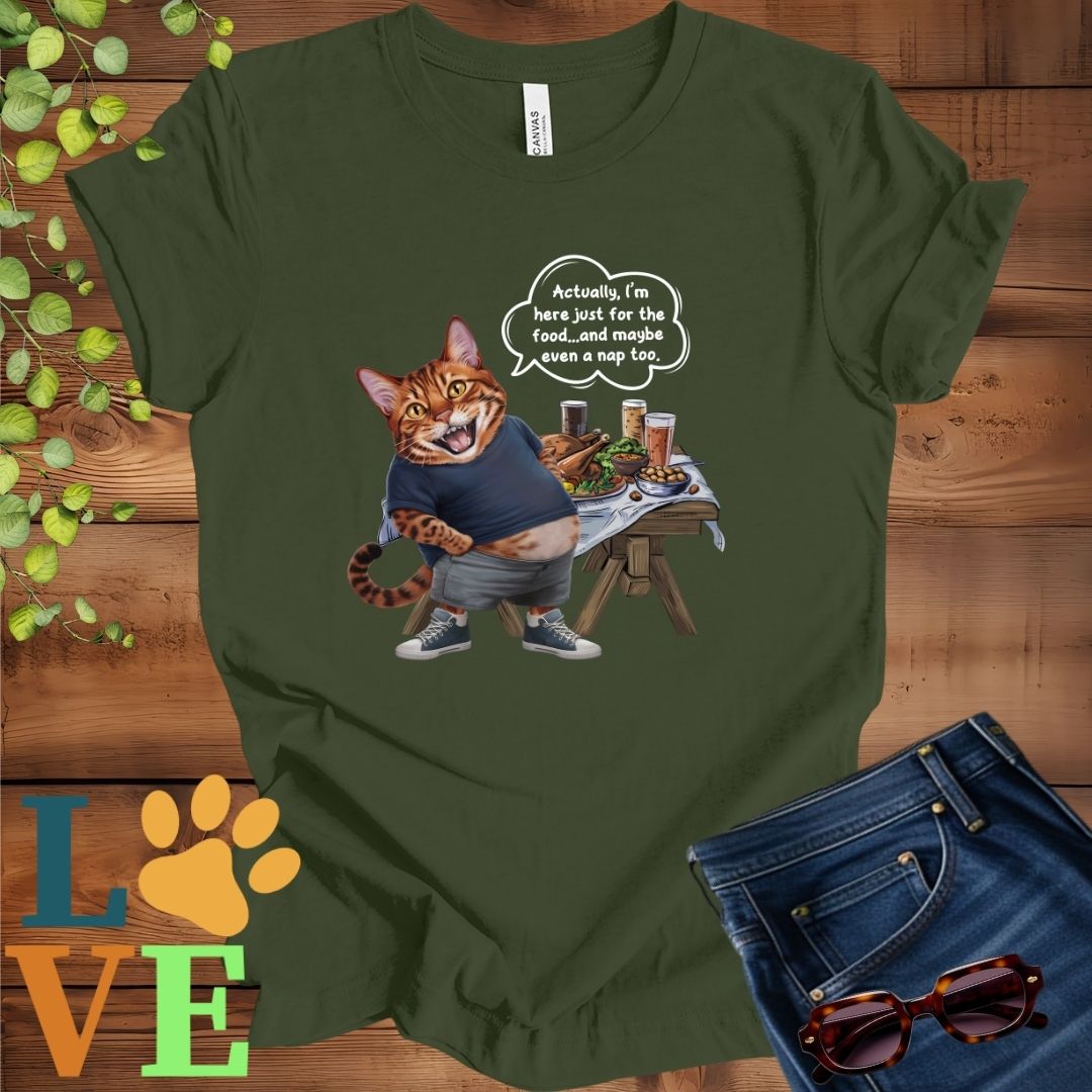 Olive green (military green) t-shirt with an anthropomorphic Bengal cat, standing in front of a table with food and drinks, showing its pot belly and humorous speech bubble message.