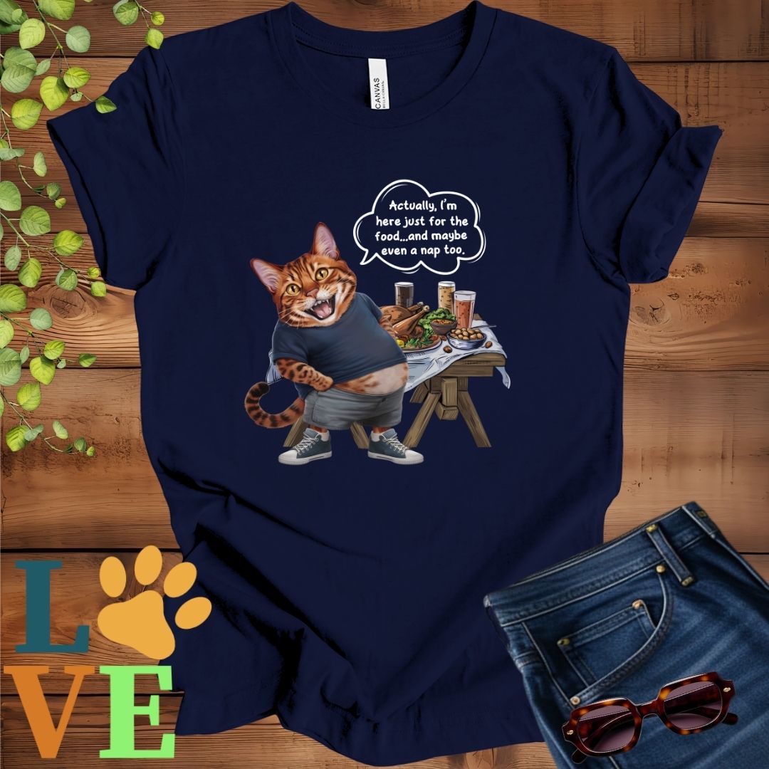Navy blue t-shirt with an anthropomorphic Bengal cat, standing in front of a table with food and drinks, showing its pot belly and humorous speech bubble message.
