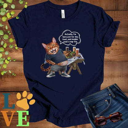 Navy blue t-shirt with an anthropomorphic Bengal cat, standing in front of a table with food and drinks, showing its pot belly and humorous speech bubble message.
