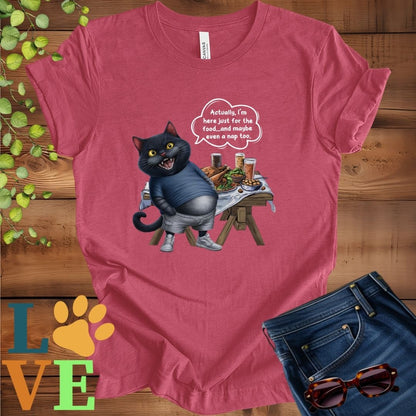 Muted raspberry pink (heather raspberry) t-shirt with an anthropomorphic black cat, standing in front of a table with food and drinks, showing its pot belly and humorous speech bubble message.