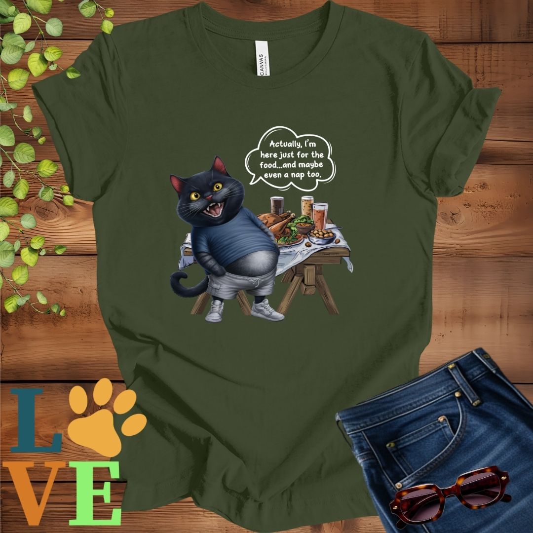 Olive green (military green) t-shirt with an anthropomorphic black cat, standing in front of a table with food and drinks, showing its pot belly and humorous speech bubble message.