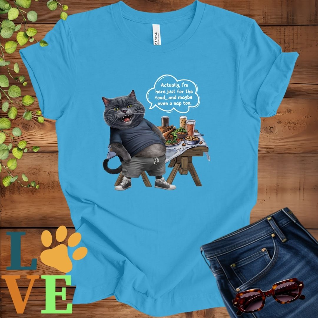 Bright aqua blue t-shirt with an anthropomorphic dark gray British Shorthair cat, standing in front of a table with food and drinks, showing its pot belly and humorous speech bubble message.