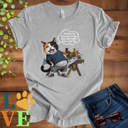 Light grey heather (athletic heather) t-shirt with an anthropomorphic calico cat, standing in front of a table with food and drinks, showing its pot belly and humorous speech bubble message.