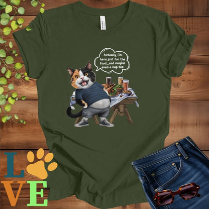 Olive green (military green) t-shirt with an anthropomorphic calico cat, standing in front of a table with food and drinks, showing its pot belly and humorous speech bubble message.
