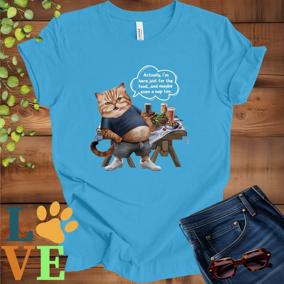 Bright aqua blue t-shirt with an anthropomorphic Exotic Shorthair cat, standing in front of a table with food and drinks, showing its pot belly and humorous speech bubble message.