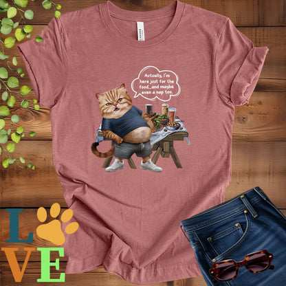 Muted mauve-purple (heather mauve) t-shirt with an anthropomorphic Exotic Shorthair cat, standing in front of a table with food and drinks, showing its pot belly and humorous speech bubble message.