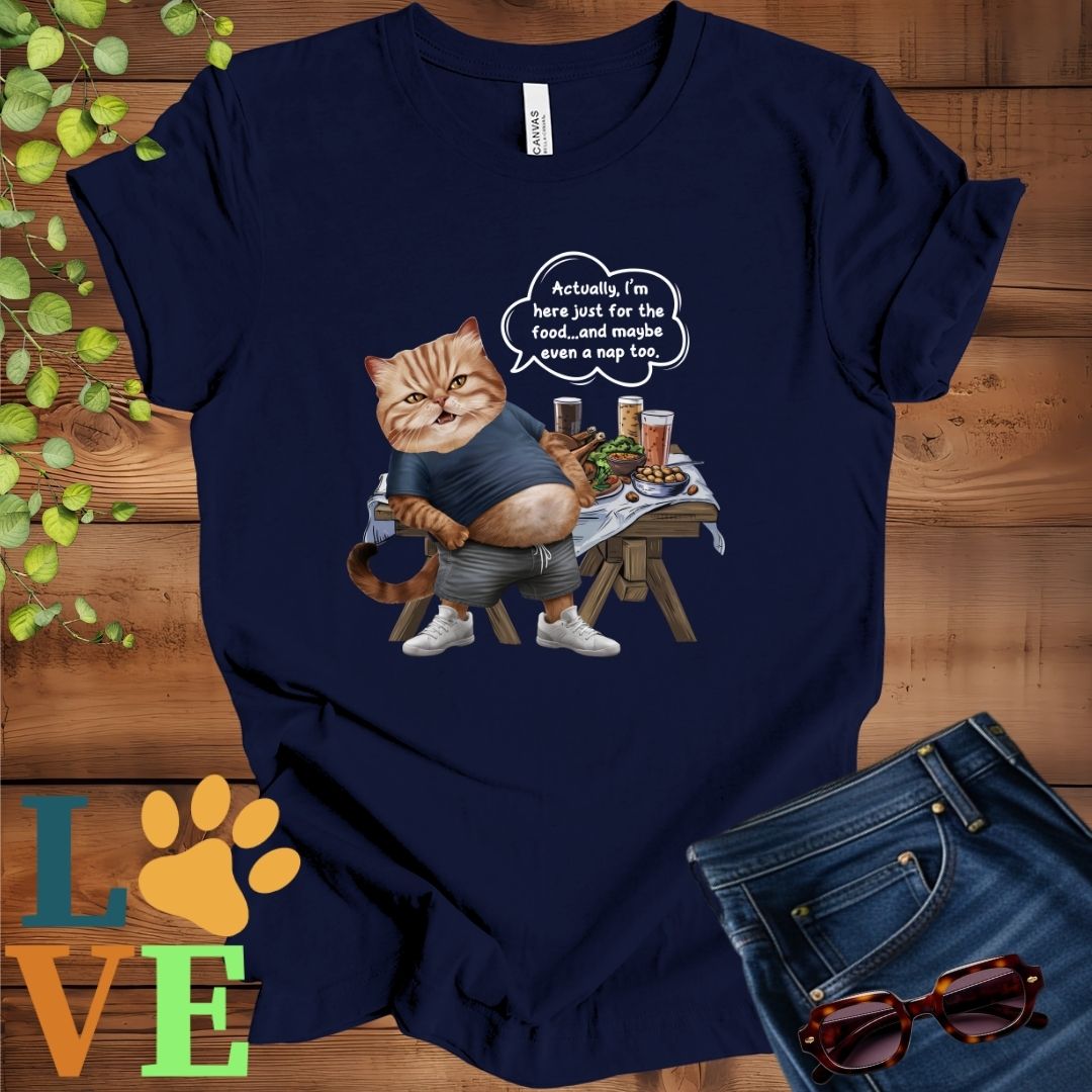 Navy blue t-shirt with an anthropomorphic Exotic Shorthair cat, standing in front of a table with food and drinks, showing its pot belly and humorous speech bubble message.