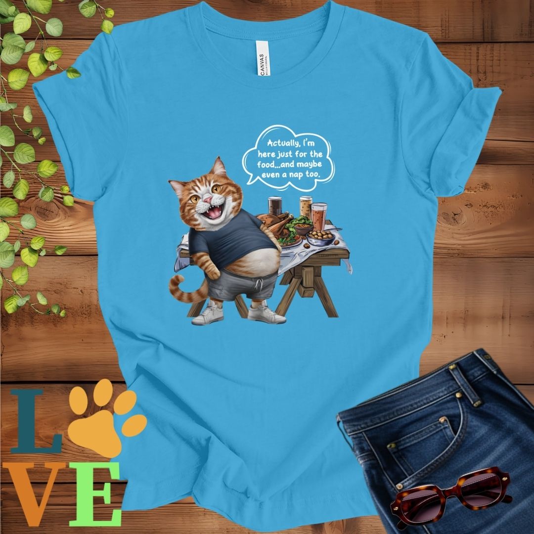 Bright aqua blue t-shirt with an anthropomorphic ginger cat, standing in front of a table with food and drinks, showing its pot belly and humorous speech bubble message.