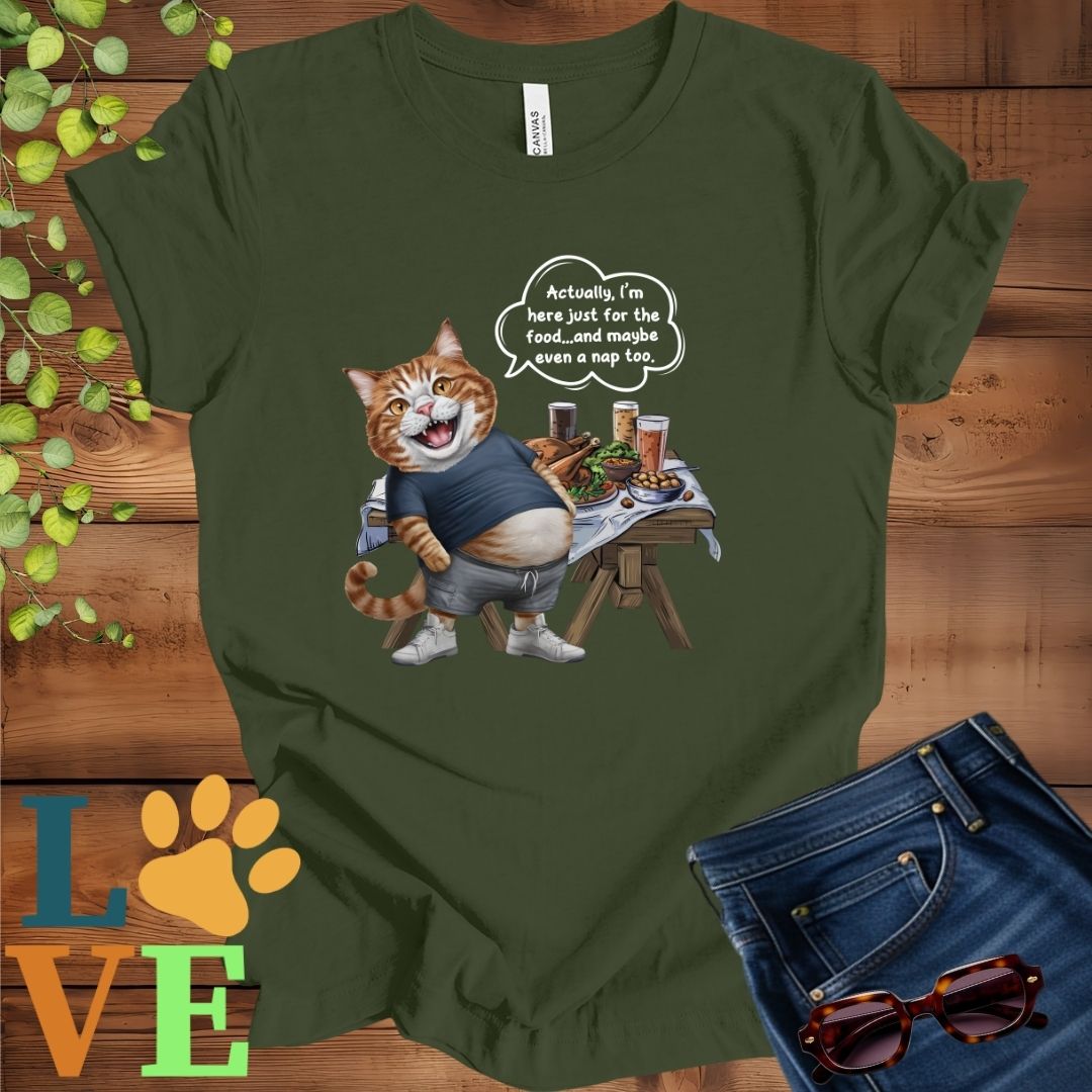 Olive green (military green) t-shirt with an anthropomorphic ginger cat, standing in front of a table with food and drinks, showing its pot belly and humorous speech bubble message.