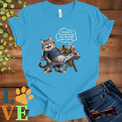 Bight aqua blue t-shirt with an anthropomorphic Maine Coon cat, standing in front of a table with food and drinks, showing its pot belly and humorous speech bubble message.