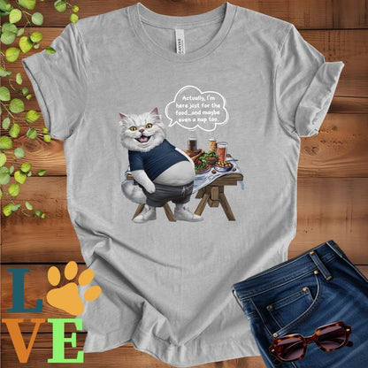 Light grey heather (athletic heather) t-shirt with an anthropomorphic Persian cat, standing in front of a table with food and drinks, showing its pot belly and humorous speech bubble message.