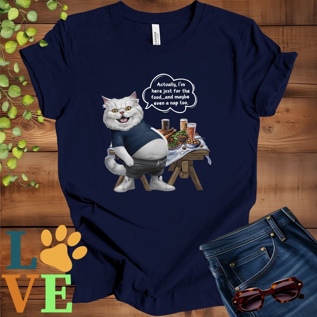 Navy blue t-shirt with an anthropomorphic Persian cat, standing in front of a table with food and drinks, showing its pot belly and humorous speech bubble message.