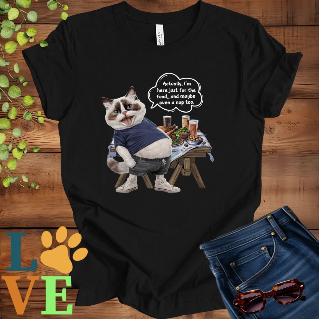 Black t-shirt with an anthropomorphic Ragdoll cat, standing in front of a table with food and drinks, showing its pot belly and humorous speech bubble message.